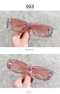 Detailed side and back view of pink rectangular sunglasses with rhinestones and spikes