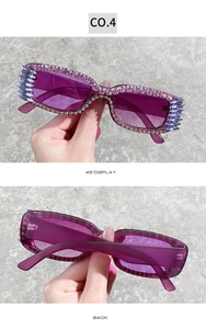Detail of purple square sunglasses with dense rhinestones and crystal spikes on the frame