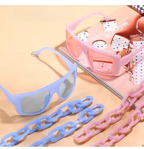 Chic square sunglasses featuring oversized frames and matching chunky acrylic chain straps