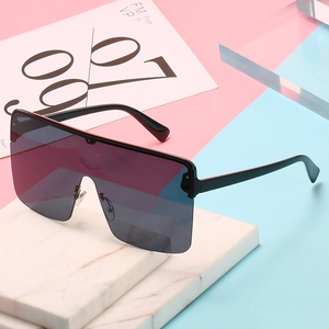Oversized shield sunglasses with black frame and gradient lenses on a modern background
