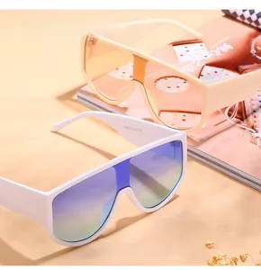 Detail of oversized shield sunglasses with gradient lenses and stylish cream frames