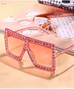 Detail of pink oversized square sunglasses with sparkling rhinestone embellishments