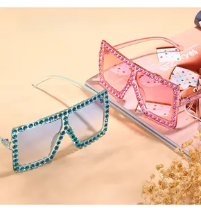 Close-up of oversized square sunglasses with sparkling rhinestone embellishments