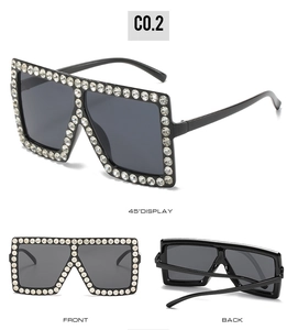 Macro view of oversized square sunglasses with crystal rhinestones and grey lenses