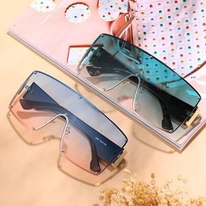Oversized wrap-around shield sunglasses with gradient lenses and gold metal frames