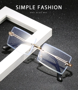 Modern square rimless anti-blue light glasses with gold metal frames on starry background