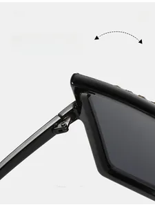 Detailed close-up of durable metal hinge on black oversized rhinestone sunglasses