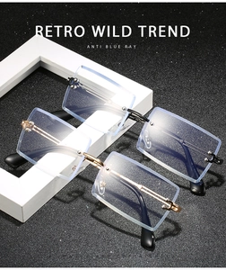 Detail view of two pairs of rimless rectangular anti-blue light glasses with metal temples