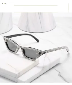 Close-up of luxury cat-eye sunglasses with hand-set sparkling crystals on black frame