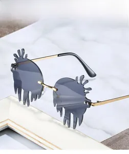 Close-up of irregular flame-shaped dark gray lenses with premium gold metal frames