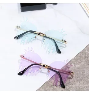 Macro view of blue and purple irregular caterpillar shaped rimless lenses and gold frame