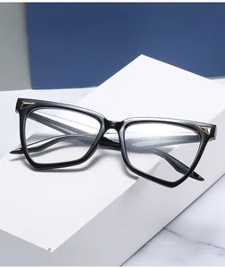 Detail of geometric cat-eye glasses frame featuring gold metal triangular accents