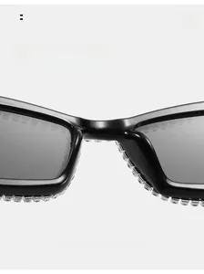 Detail of luxury black oversized sunglasses with hand-set rhinestones and integrated nose pad