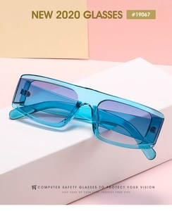 Detail view of retro square blue transparent frame glasses with purple gradient lenses