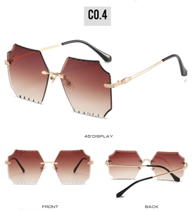Detail of frameless sunglasses with gradient brown lenses and scalloped wave-cut edges