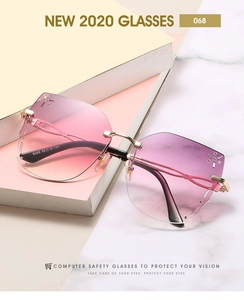 Detail of pink gradient rimless butterfly sunglasses with rhinestones and gold metal arms