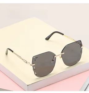 Detailed close-up of butterfly rimless sunglasses with hand-set rhinestones and gold temples