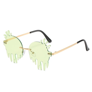 Melting green caterpillar shaped sunglasses with gold metal frame and rimless lenses
