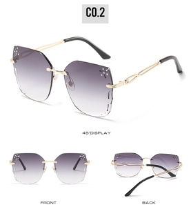 Detail view of purple gradient rimless sunglasses with rhinestone accents and gold temples