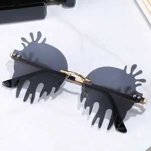 Unique irregular fluid shape sunglasses with grey lenses and gold metal temples