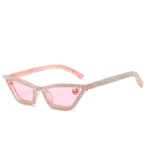 Pink cat-eye sunglasses with hand-set rhinestones and decorative gemstones