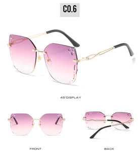 Detail view of rimless butterfly sunglasses with purple gradient lenses and rhinestone accents