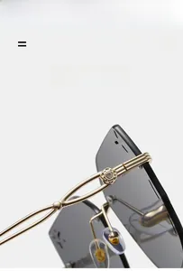 Detail of gold metal temples with floral engraving and crystal on rimless sunglasses