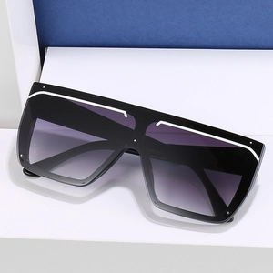 Flat top oversized square sunglasses with black frame and gradient lenses on blue background