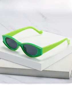 Close-up of bright green small oval sunglasses with dark lenses on marble display