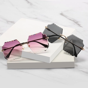 Frameless square sunglasses with geometric cut lenses and luxury gold metal temples