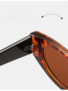 Macro detail of a durable metal hinge on tortoiseshell oval sunglasses frame