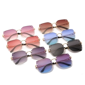 Frameless butterfly sunglasses with rhinestone accents and gradient lenses in multiple colors