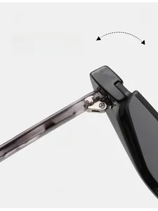 Vue macro détaillée de la charnière en métal durable sur lunettes de soleil noires