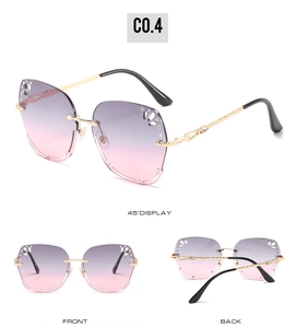 Detail of rimless gradient sunglasses with butterfly cutout and rhinestone accents