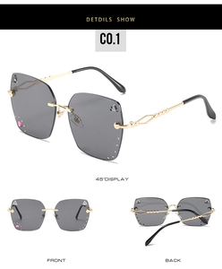 Detailed views of grey lens rimless sunglasses with heart crystals and gold metal temples