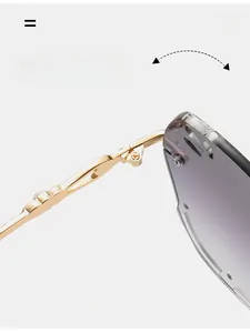 Detail of durable gold metal hinge and gradient purple rimless lens on square sunglasses