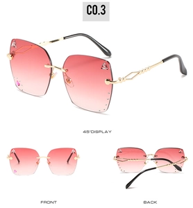 Detail of rimless sunglasses with pink gradient lenses and rhinestone heart accents
