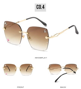 Detail of rimless gradient sunglasses with crystal heart accent and gold hollow woven temples