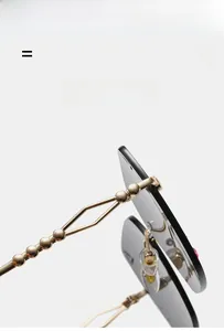 Detail view of gold beaded temples and pink rhinestones on rimless sunglasses