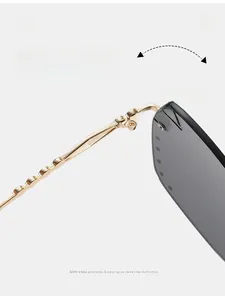 Detail of durable gold textured metal hinge and grey rimless lens on stylish sunglasses