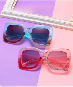 Detail of square oversized gradient sunglasses with S-shaped rhinestone embellishments