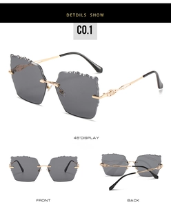 Three-angle view of rimless cat-eye sunglasses with gold metal wave frames and dark lenses