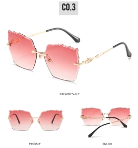 Three-view display showing gradient pink rimless sunglasses with wavy cut lenses and gold metal frame