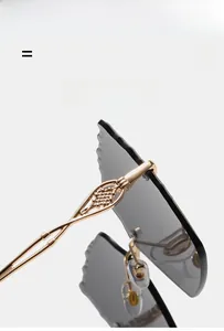 Detail of light gold metal temple with textured grid and rimless grey wave-cut lens