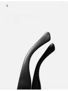 Detail of ergonomic curved mirror legs on black oversized square sunglasses