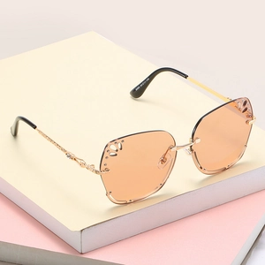 Frameless square sunglasses for women with hollow gradient lenses and gold rhinestone temples