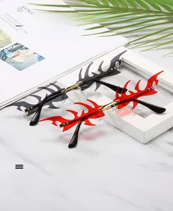 Detail of rimless flame-shaped sunglasses with gold temples on a stylish background