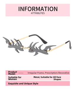 Detail view of gold metal temples and grey flame-shaped lenses on rimless sunglasses