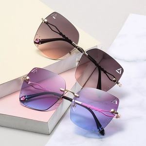 Frameless gradient sunglasses with diamond accents and gold wavy metal temples for women