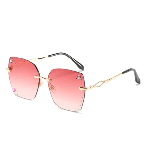 Fashionable rimless gradient pink sunglasses with rhinestone accents and gold metal temples